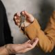 pexels-photo-7642004-7642004 Two adults exchanging house keys, symbolic of property transfer or rental agreement.